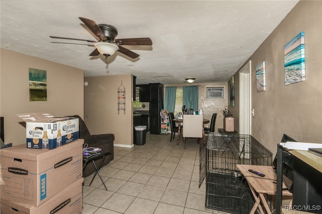 living room featuring ceiling fan, light tile patterned floors, a textured ceiling, and an AC wall unit