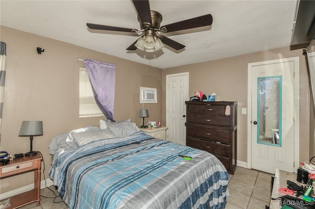 tiled bedroom featuring ceiling fan