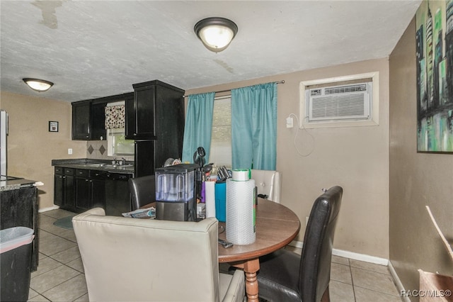 dining area featuring light tile patterned flooring, an AC wall unit, and sink