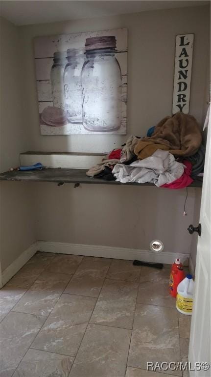 bathroom with tile patterned floors and baseboards