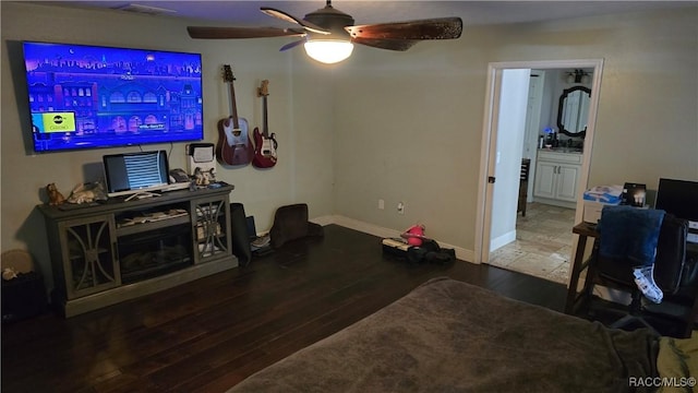 living room featuring ceiling fan and hardwood / wood-style floors