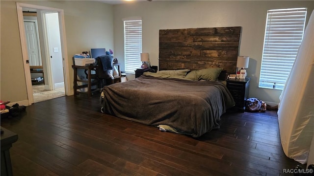 bedroom featuring baseboards and dark wood-style flooring