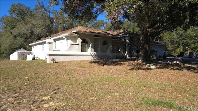 view of front of property featuring stucco siding and a front yard