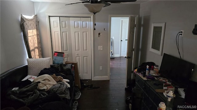 bedroom featuring dark hardwood / wood-style flooring, a closet, and ceiling fan