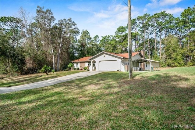 view of front of house featuring a garage, driveway, a chimney, and a front lawn