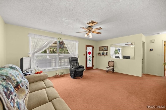 9708 W Hawthorne St, Crystal River, FL 34428 - carpeted living area with a wealth of natural light, visible vents, ceiling fan, and a textured ceiling