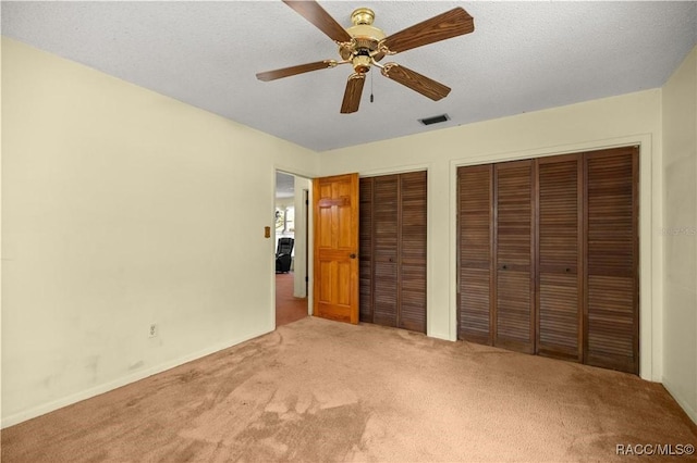 9708 W Hawthorne St, Crystal River, FL 34428 - unfurnished bedroom with visible vents, two closets, carpet floors, a ceiling fan, and baseboards