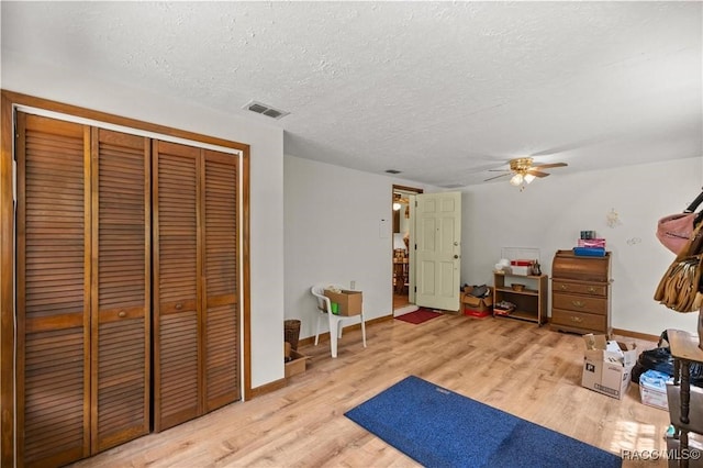 9708 W Hawthorne St, Crystal River, FL 34428 - interior space with a textured ceiling, visible vents, wood finished floors, and a ceiling fan