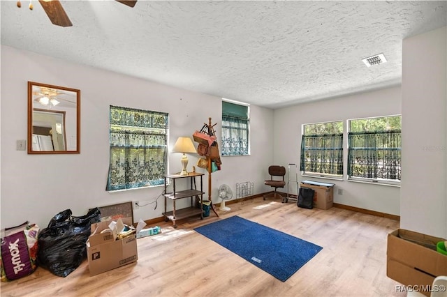 9708 W Hawthorne St, Crystal River, FL 34428 - exercise room featuring a ceiling fan, visible vents, a textured ceiling, and wood finished floors