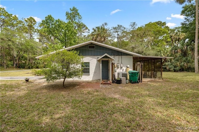 9708 W Hawthorne St, Crystal River, FL 34428 - back of property with a yard, central AC unit, and a sunroom