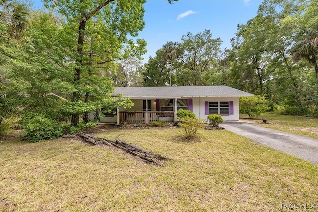 9708 W Hawthorne St, Crystal River, FL 34428 - ranch-style home featuring a front yard, a porch, and driveway