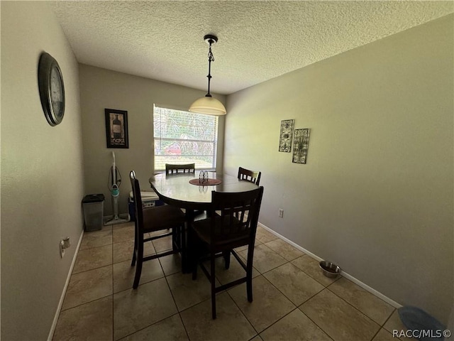 tiled dining room with a textured ceiling