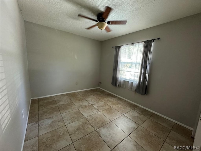 empty room with light tile patterned floors, a textured ceiling, and ceiling fan