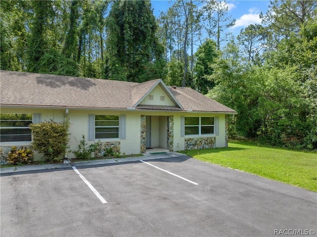 ranch-style home with a front lawn