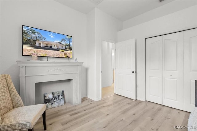 12 Colubrina Ct, Homosassa, FL 34446 - sitting room with light wood-style flooring and a fireplace