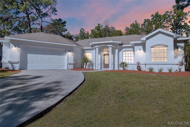 single story home with a yard and a garage