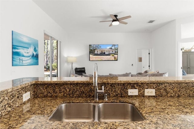 12 Colubrina Ct, Homosassa, FL 34446 - kitchen with a sink, stone countertops, open floor plan, and ceiling fan