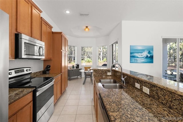 12 Colubrina Ct, Homosassa, FL 34446 - kitchen featuring appliances with stainless steel finishes, a sink, light tile patterned flooring, dark stone counters, and recessed lighting