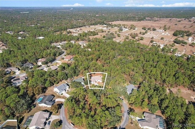 12 Colubrina Ct, Homosassa, FL 34446 - aerial view of property and surrounding area with property boundaries highlighted, nearby suburban area, and a heavily wooded area