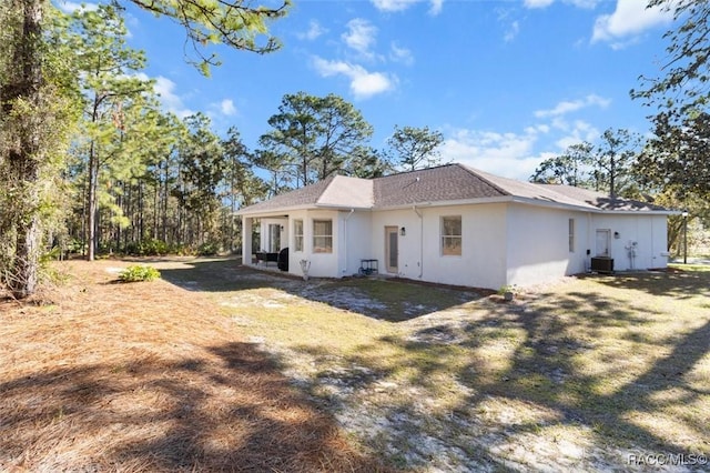 12 Colubrina Ct, Homosassa, FL 34446 - back of house featuring stucco siding and a shingled roof