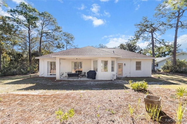 12 Colubrina Ct, Homosassa, FL 34446 - back of house with stucco siding, a patio area, and outdoor lounge area