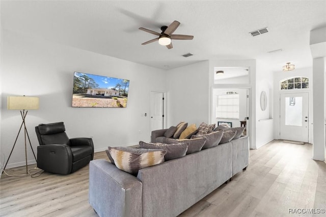 12 Colubrina Ct, Homosassa, FL 34446 - living room with light wood finished floors, ceiling fan, and baseboards