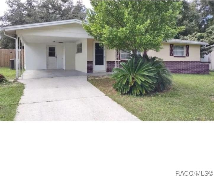 60 Roosevelt Blvd, Beverly Hills, FL 34465 - single story home featuring driveway, a front yard, fence, and stucco siding