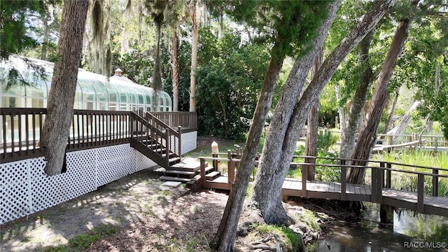 750 NW Snug Harbor Rd, Crystal River, FL 34428 - wooden deck with a sunroom