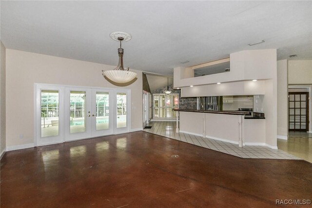 750 NW Snug Harbor Rd, Crystal River, FL 34428 - unfurnished living room with french doors, concrete flooring, healthy amount of natural light, and baseboards