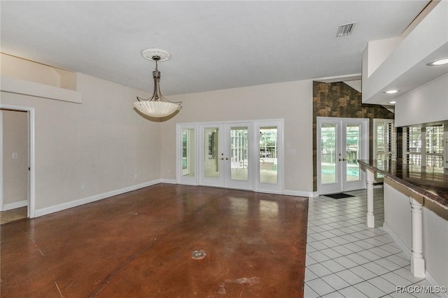 750 NW Snug Harbor Rd, Crystal River, FL 34428 - unfurnished dining area featuring french doors, baseboards, and concrete flooring