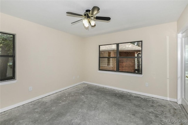 750 NW Snug Harbor Rd, Crystal River, FL 34428 - spare room with concrete floors, baseboards, and a ceiling fan
