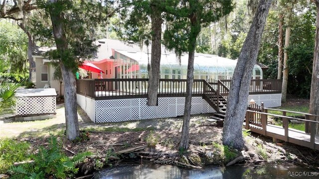 750 NW Snug Harbor Rd, Crystal River, FL 34428 - deck with stairway and a sunroom