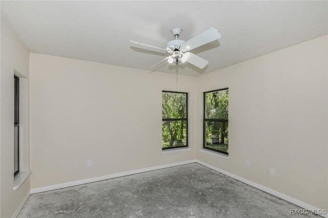 750 NW Snug Harbor Rd, Crystal River, FL 34428 - empty room with baseboards, a ceiling fan, and unfinished concrete floors