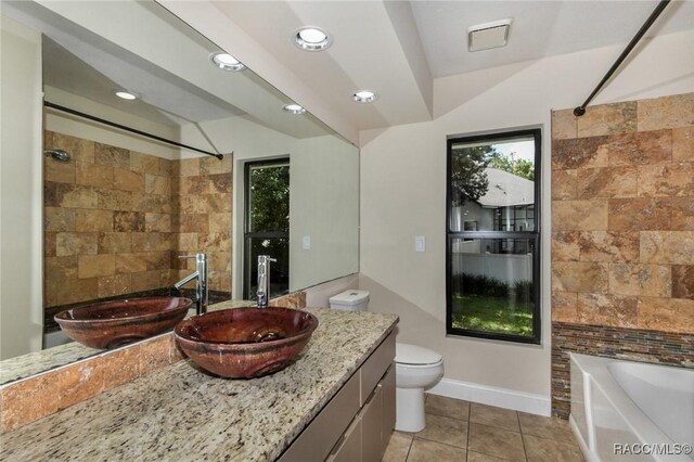 750 NW Snug Harbor Rd, Crystal River, FL 34428 - full bath with toilet, vanity, tile patterned floors, shower / bathtub combination, and baseboards