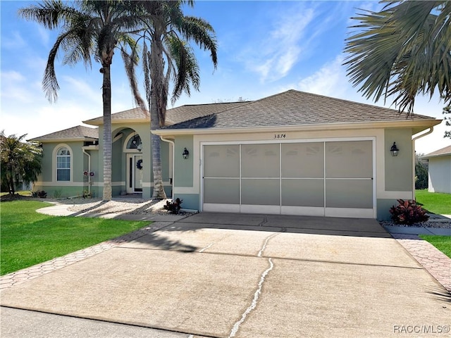 single story home with concrete driveway, roof with shingles, an attached garage, a front lawn, and stucco siding