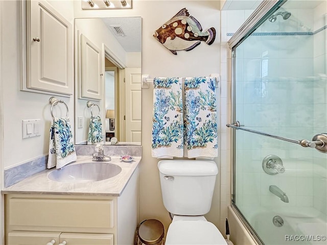 bathroom with toilet, vanity, visible vents, and enclosed tub / shower combo