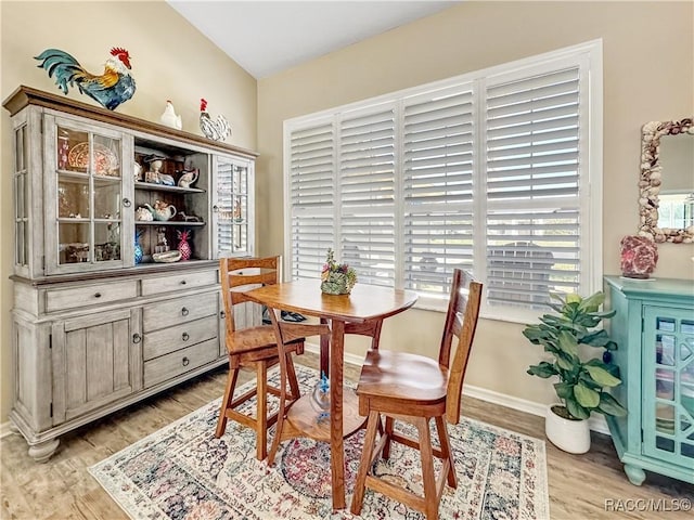 dining room featuring baseboards and light wood-style floors