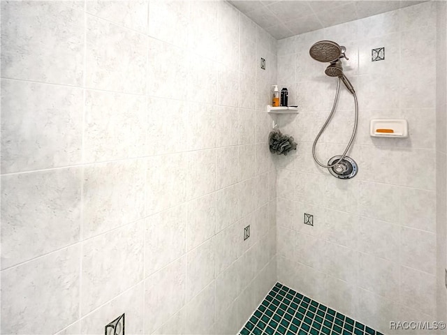 full bath featuring a tile shower