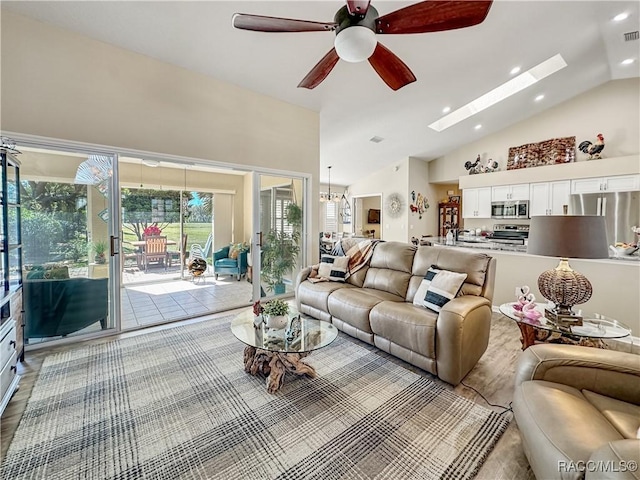 living area with a skylight, recessed lighting, visible vents, ceiling fan, and wood finished floors