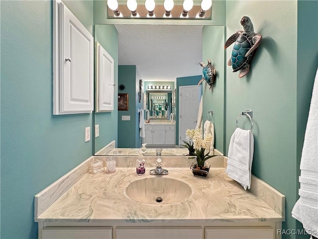 bathroom with a textured ceiling and vanity