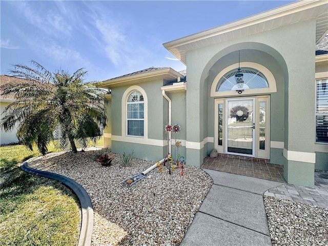 property entrance with stucco siding