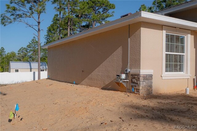 7792 N Susan Ave, Dunnellon, FL 34433 - view of side of property with stucco siding and fence
