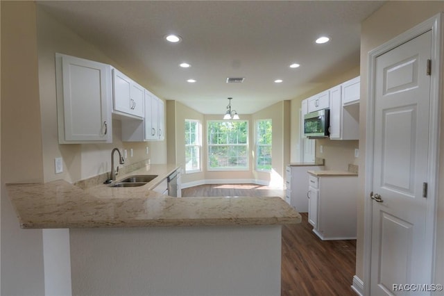 7792 N Susan Ave, Dunnellon, FL 34433 - kitchen featuring recessed lighting, appliances with stainless steel finishes, light stone countertops, a peninsula, and dark wood finished floors