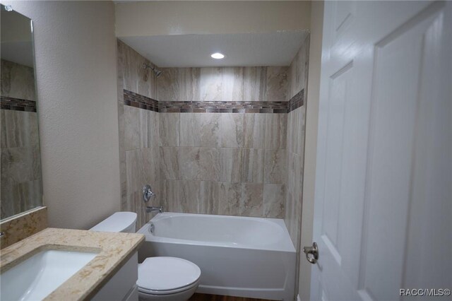 7792 N Susan Ave, Dunnellon, FL 34433 - bathroom featuring toilet, vanity, bathtub / shower combination, and a textured wall