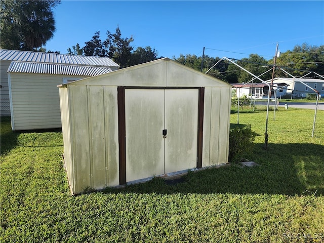 view of outbuilding featuring a yard