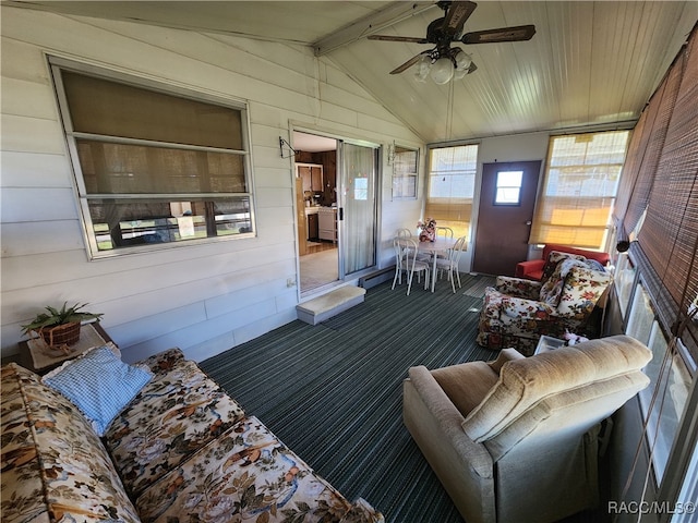 sunroom / solarium with ceiling fan and lofted ceiling with beams