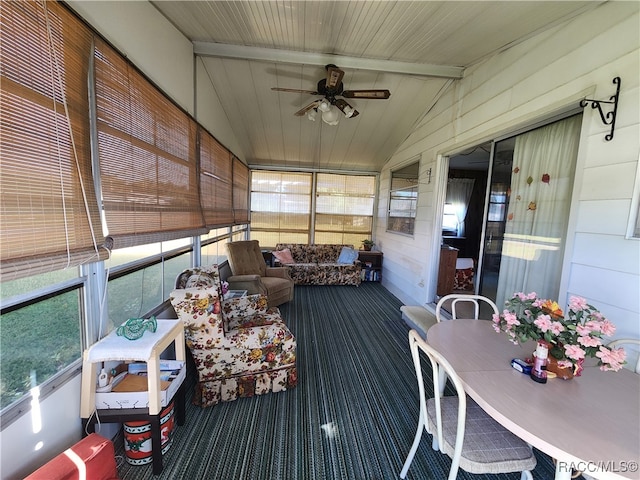 sunroom / solarium featuring vaulted ceiling with beams, ceiling fan, and wood ceiling