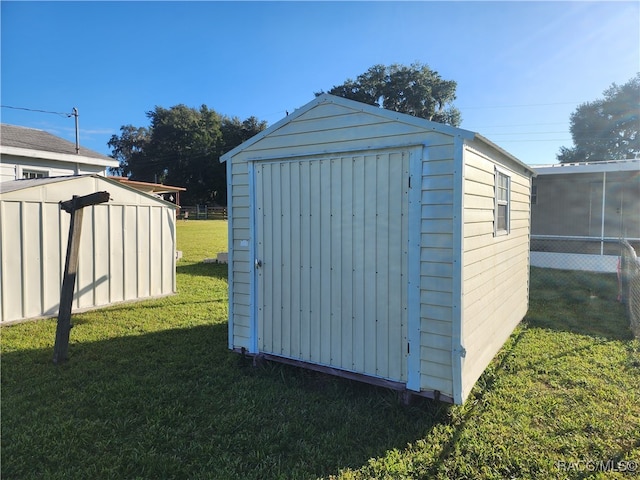 view of outbuilding with a lawn