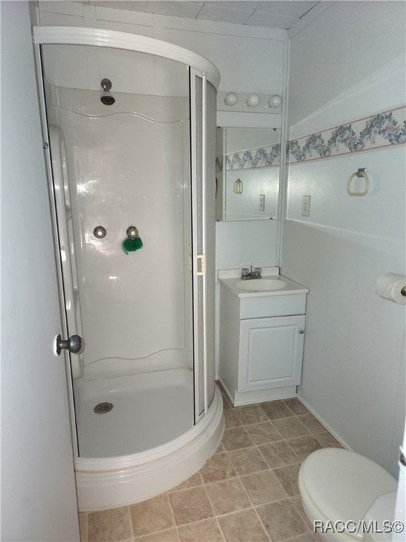 bathroom with vanity, toilet, and walk in shower