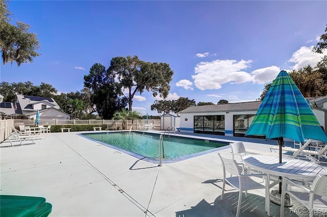 1309 Longboat Pt, Inverness, FL 34450 - pool with a patio, fence, and an outbuilding